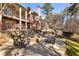 Charming backyard patio with an outdoor fireplace and stone seating, offering a serene space for relaxation and socializing at 2250 Blackheath Trce, Alpharetta, GA 30005