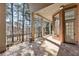Covered patio with stone flooring, brick supports, and a view of the wooded backyard at 2250 Blackheath Trce, Alpharetta, GA 30005