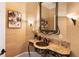 Stylish powder room boasts unique sink and vanity at 2250 Blackheath Trce, Alpharetta, GA 30005