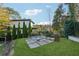 This backyard boasts a stone-paved patio area with modern fire pit and chairs at 4333 Rickenbacker Ne Way, Atlanta, GA 30342