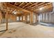 Unfinished basement with exposed wood beams, concrete walls, and a walk-out door at 4333 Rickenbacker Ne Way, Atlanta, GA 30342