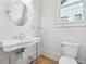 Elegant half-bath features a vintage sink and classic toilet for a timeless and stylish design at 4333 Rickenbacker Ne Way, Atlanta, GA 30342