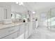 Bright bathroom featuring dual sinks, a big mirror, and a glass shower at 4333 Rickenbacker Ne Way, Atlanta, GA 30342