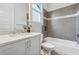 Updated bathroom featuring gray tiling, modern fixtures, and bright natural light creating a sleek design at 4333 Rickenbacker Ne Way, Atlanta, GA 30342