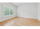Bright, airy bedroom with natural light flooding in from large windows, showcasing the beautiful hardwood floors at 4333 Rickenbacker Ne Way, Atlanta, GA 30342
