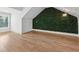 This bedroom offers an accent wall, wood floors and a chandelier-style lighting fixture at 4333 Rickenbacker Ne Way, Atlanta, GA 30342