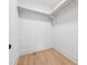 Empty closet with hardwood floors, ample space, and shelving for optimal organization in a minimalistic design at 4333 Rickenbacker Ne Way, Atlanta, GA 30342