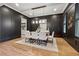 Stylish dining room with a long table, dark paneled walls, and hardwood flooring at 4333 Rickenbacker Ne Way, Atlanta, GA 30342