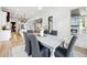Bright dining room featuring a gray table with six chairs, wood floors, and an elegant chandelier at 4333 Rickenbacker Ne Way, Atlanta, GA 30342