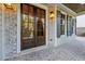 Inviting entryway features a wood double door, brickwork, sidelights, and porch lanterns at 4333 Rickenbacker Ne Way, Atlanta, GA 30342