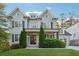 Charming two-story home with a manicured lawn, gray shingles, a brick facade, and a welcoming front porch at 4333 Rickenbacker Ne Way, Atlanta, GA 30342
