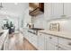 Elegant kitchen with white cabinets, stainless steel appliances, marble countertops, and an eat-in dining area at 4333 Rickenbacker Ne Way, Atlanta, GA 30342