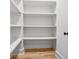 Walk-in pantry with white shelving and hardwood floors at 4333 Rickenbacker Ne Way, Atlanta, GA 30342