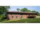Expansive backyard with a brick home featuring a wooden deck and ample green space at 4643 Wesley Dr, Austell, GA 30106