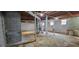 View of the home's unfinished basement with concrete block walls, exposed ductwork, and small windows at 4643 Wesley Dr, Austell, GA 30106