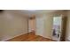A bedroom with hardwood floors and a view into a bathroom at 4643 Wesley Dr, Austell, GA 30106