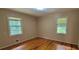 Bright bedroom with hardwood floors, neutral walls, and two windows that provide ample natural light at 4643 Wesley Dr, Austell, GA 30106
