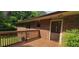 Exterior view featuring a wooden deck and access door to a brick home at 4643 Wesley Dr, Austell, GA 30106