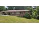 Charming one-story brick home with well-maintained lawn and covered parking at 4643 Wesley Dr, Austell, GA 30106