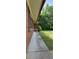 Exterior view of brick home with a concrete walkway, tidy lawn, and mature trees at 4643 Wesley Dr, Austell, GA 30106
