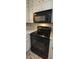 Image of stove and microwave appliance in kitchen featuring white cabinets and light countertops at 4643 Wesley Dr, Austell, GA 30106