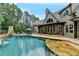 Stunning backyard featuring a large swimming pool, stone patio, and a lush green lawn at 829 Big Horn Holw, Suwanee, GA 30024