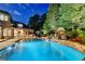 Enjoy the evening in this backyard with a large pool, spa, stone patio and water feature at 829 Big Horn Holw, Suwanee, GA 30024