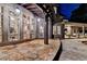 Covered patio with many windows, tile flooring, stone work and lush plants creating an elegant entertainment space at 829 Big Horn Holw, Suwanee, GA 30024