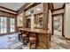 This area offers a bar with seating, wooden cabinetry, and outdoor access at 829 Big Horn Holw, Suwanee, GA 30024
