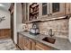The wet bar area features brick accents, a sink, and ample cabinet space at 829 Big Horn Holw, Suwanee, GA 30024