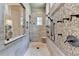 A modern bathroom with multiple shower heads and tiled walls at 829 Big Horn Holw, Suwanee, GA 30024