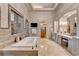 Luxurious bathroom with soaking tub, vanity, and elegant fixtures at 829 Big Horn Holw, Suwanee, GA 30024