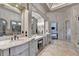 This bathroom features a seated vanity with dual mirrors and decorative wall coverings at 829 Big Horn Holw, Suwanee, GA 30024