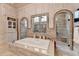This primary bathroom features a soaking tub and walk-in shower with extensive tiling at 829 Big Horn Holw, Suwanee, GA 30024