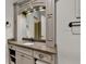 Bathroom vanity with granite countertop, decorative mirror, and storage cabinets at 829 Big Horn Holw, Suwanee, GA 30024