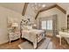Charming bedroom features hardwood floors, stylish chandelier, and a decorative wrought iron bed frame at 829 Big Horn Holw, Suwanee, GA 30024