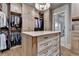 Elegant walk-in closet with a central island and custom cabinetry at 829 Big Horn Holw, Suwanee, GA 30024