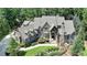 Aerial view of a large, well-maintained home surrounded by lush landscaping and mature trees at 829 Big Horn Holw, Suwanee, GA 30024