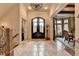 Inviting foyer featuring travertine floors, iron-accented doors, and access to the dining area at 829 Big Horn Holw, Suwanee, GA 30024