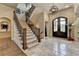 Grand foyer with staircase and wrought iron details at 829 Big Horn Holw, Suwanee, GA 30024