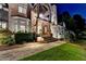 Beautiful stone and brick home with a stone walkway and meticulously landscaped front yard and lantern lit stairway at 829 Big Horn Holw, Suwanee, GA 30024