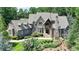 Stately stone and shingle home with manicured landscaping and charming blue shutters at 829 Big Horn Holw, Suwanee, GA 30024