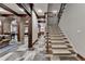 Inviting entryway features stone flooring, wood beams, and a staircase leading to upper level at 829 Big Horn Holw, Suwanee, GA 30024