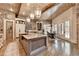 Spacious kitchen with a large center island, stainless steel appliances, and a dining area with French doors at 829 Big Horn Holw, Suwanee, GA 30024