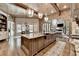 Open concept kitchen featuring a large island, stainless steel appliances, and seamless flow to the living area at 829 Big Horn Holw, Suwanee, GA 30024