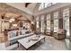 Bright living room with large windows, neutral tones, and hardwood floors, creating an inviting atmosphere at 829 Big Horn Holw, Suwanee, GA 30024