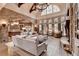 Spacious living room with brick accents, hardwood floors, and large windows creating a bright and inviting space at 829 Big Horn Holw, Suwanee, GA 30024