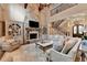 Elegant living room featuring a stone fireplace, custom built-ins, and a staircase leading to an upper level at 829 Big Horn Holw, Suwanee, GA 30024