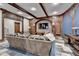 Comfortable living area features wooden beams, detailed trim, and entertainment center at 829 Big Horn Holw, Suwanee, GA 30024