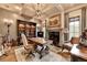 Cozy home office with a fireplace, built-in bookshelves, and a comfortable desk at 829 Big Horn Holw, Suwanee, GA 30024